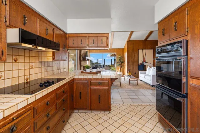 a kitchen with stainless steel appliances kitchen island granite countertop a sink and cabinets