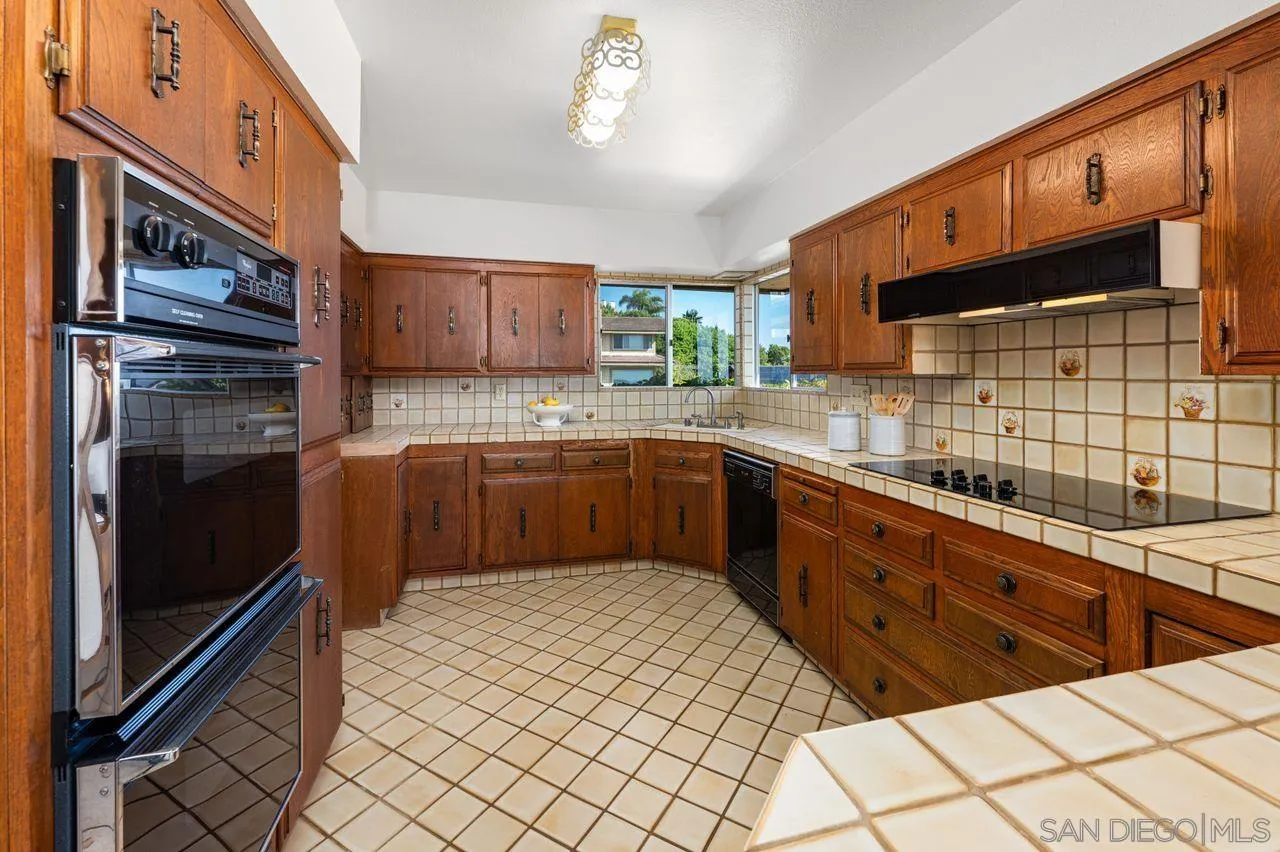 5504 Rutgers Road La Jolla, CA 92037 - Photo 20 of 53 a kitchen with stainless steel appliances a sink cabinets and wooden floor