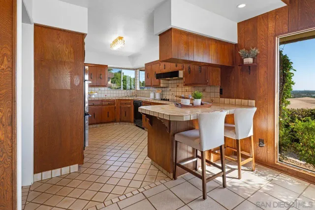 a kitchen with stainless steel appliances a sink and a refrigerator