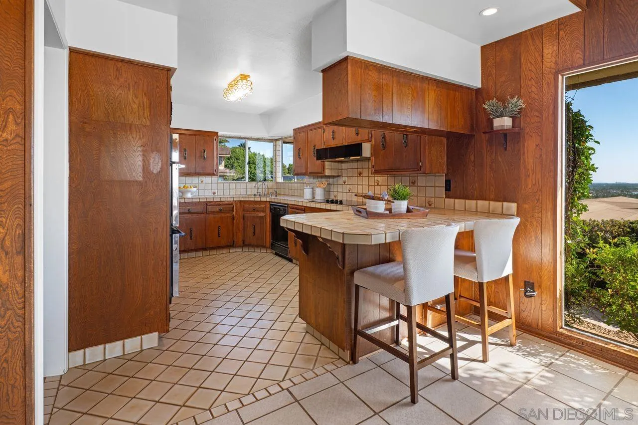 5504 Rutgers Road La Jolla, CA 92037 - Photo 22 of 53 a kitchen with stainless steel appliances a sink and a refrigerator