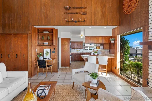 a living room with furniture and a painting on the wall