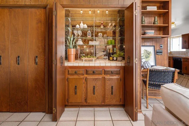 a living room with furniture a rug and a bookshelf