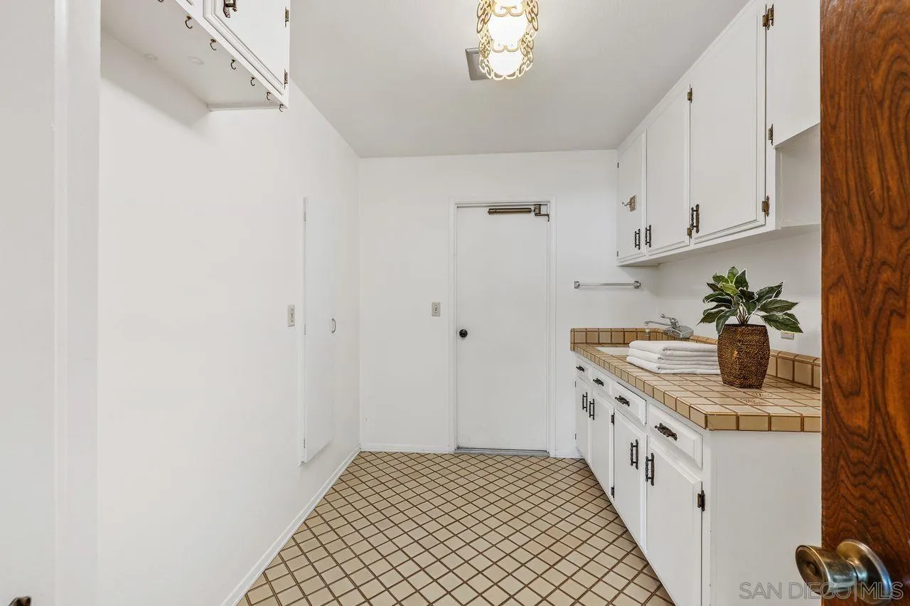 5504 Rutgers Road La Jolla, CA 92037 - Photo 36 of 53 a kitchen with stainless steel appliances a white cabinets and a stove