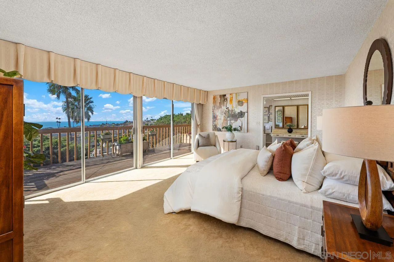 5504 Rutgers Road La Jolla, CA 92037 - Photo 41 of 53 a bedroom with a large bed and a large window
