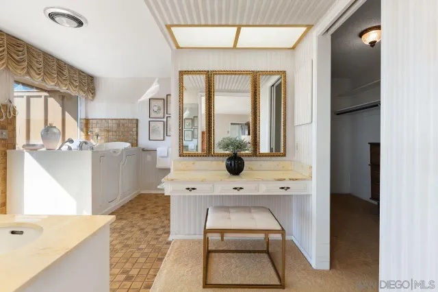a large white kitchen with a large window