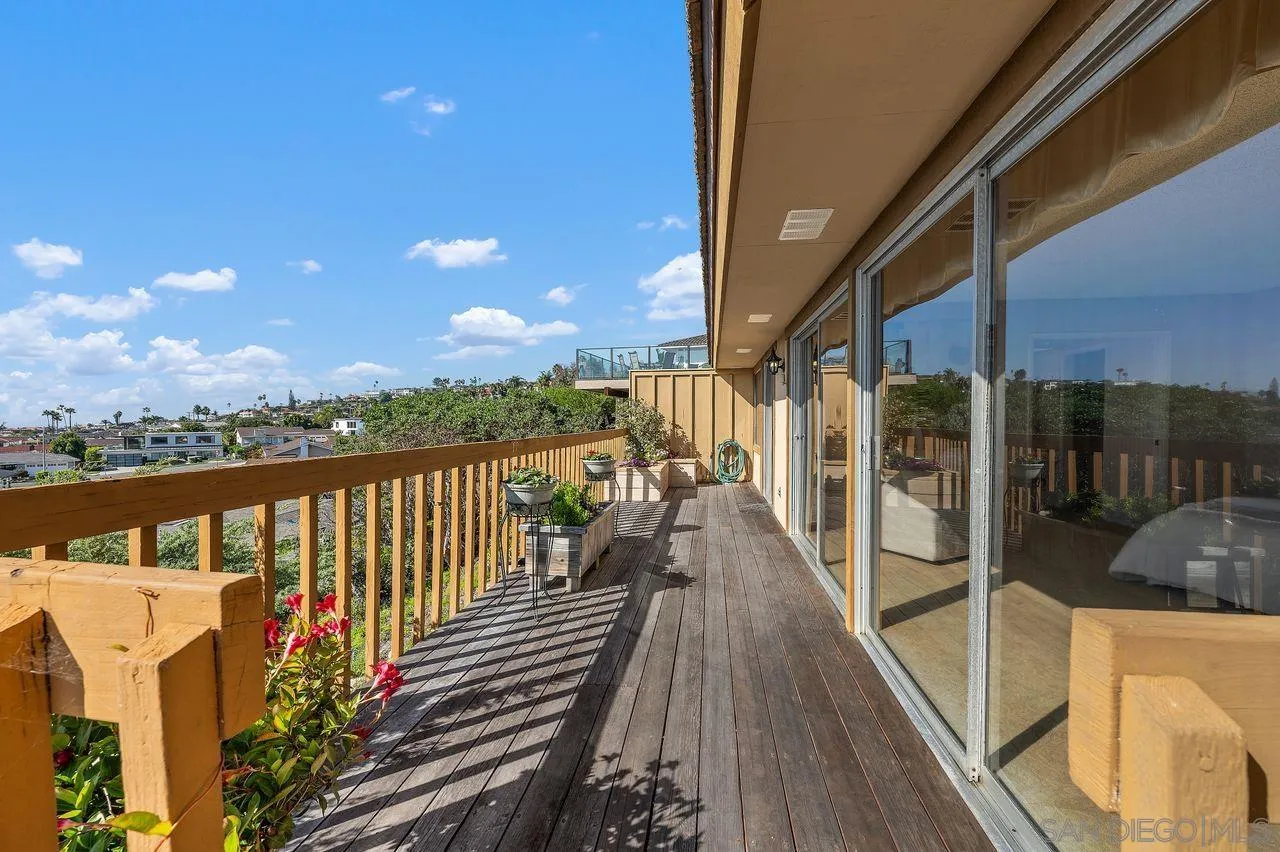 5504 Rutgers Road La Jolla, CA 92037 - Photo 47 of 53 a view of a balcony with wooden floor and iron stairs