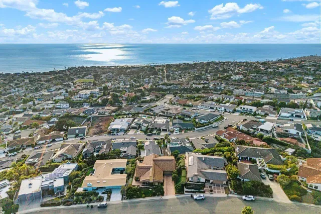 an aerial view of residential building with ocean view
