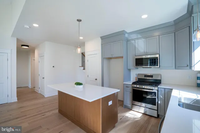 an empty room with wooden floor and a fireplace