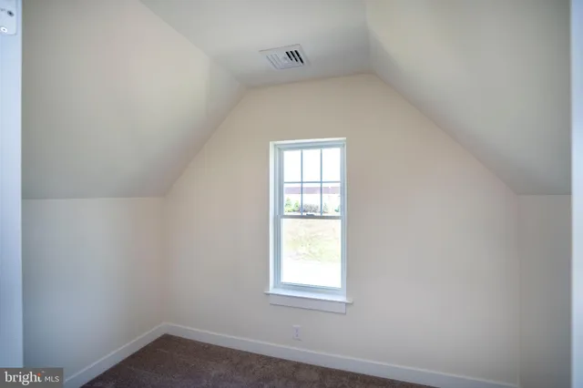 a view of an empty room and closet area
