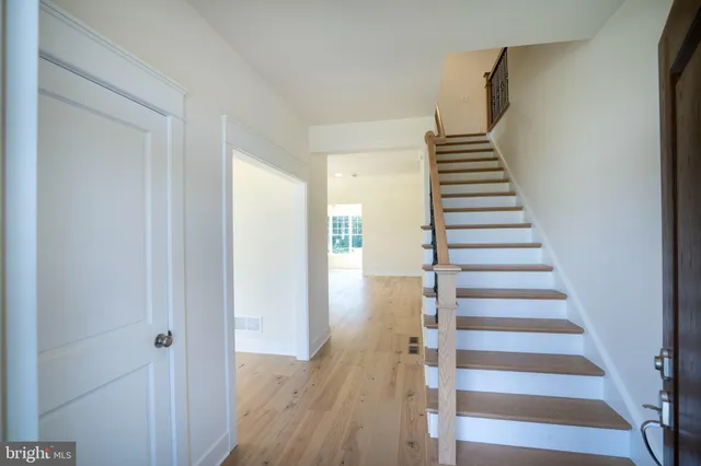 a view of a room with wooden floor and stairs
