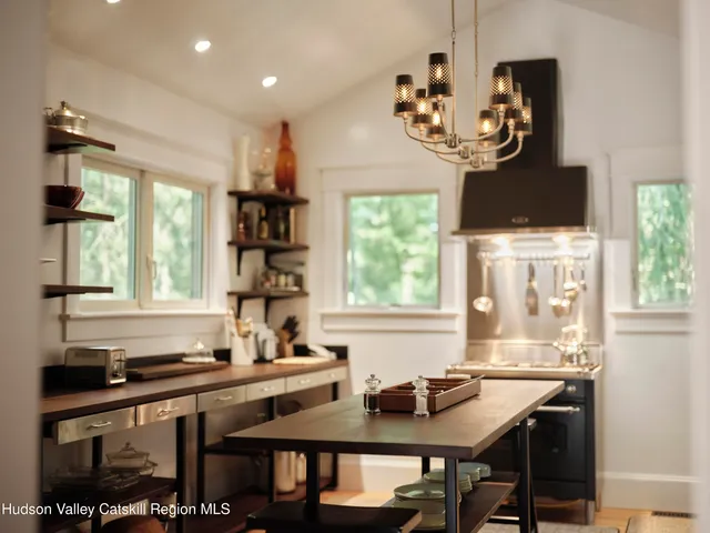 a kitchen with a table chairs a sink dishwasher window and cabinets