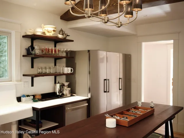 a room with furniture and view of kitchen