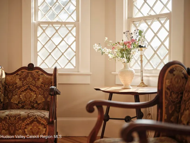 a view of a dining room with furniture and chandelier