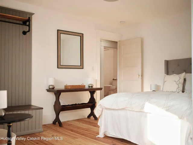 a bedroom with a bed and a lamp on table