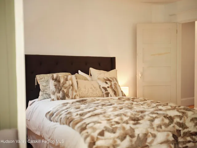 a large bed sitting in a bedroom next to a wall