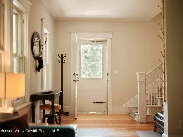 a view of a hallway with wooden floor and entryway