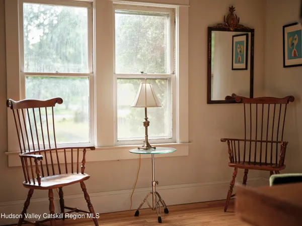 a view of a room with a window and wooden floor