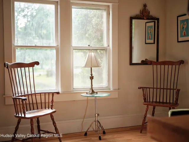 a view of a room with a window and wooden floor