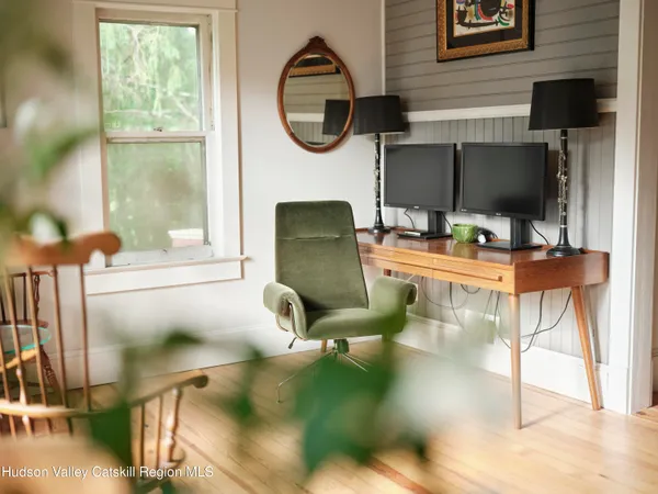 a work room with furniture and a floor to ceiling window