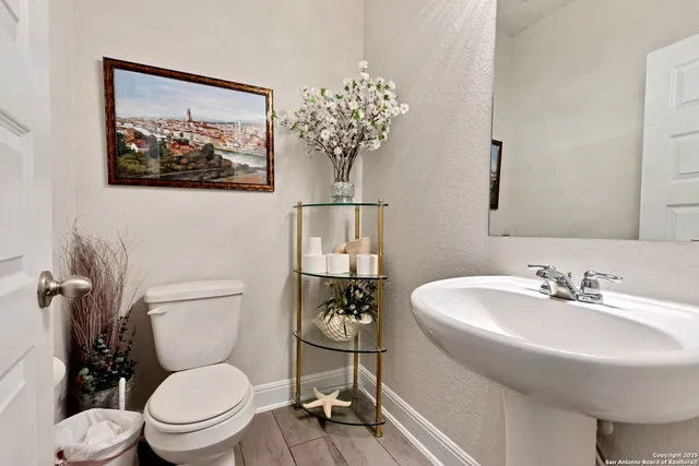 a bathroom with a toilet a sink and mirror