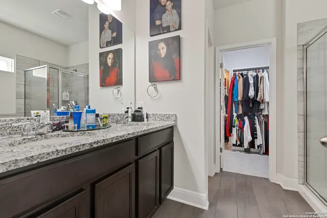 a bathroom with a double vanity sink and a mirror
