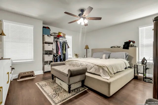 a spacious bedroom with a bed and a chandelier