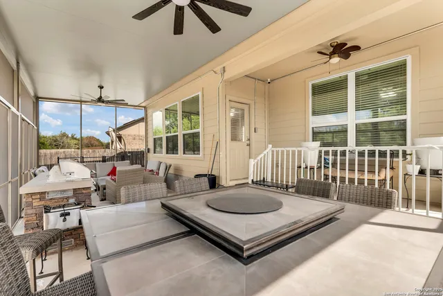 a living room with furniture a rug and a large window