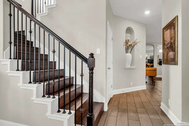 a view of staircase with wooden floor and stairs
