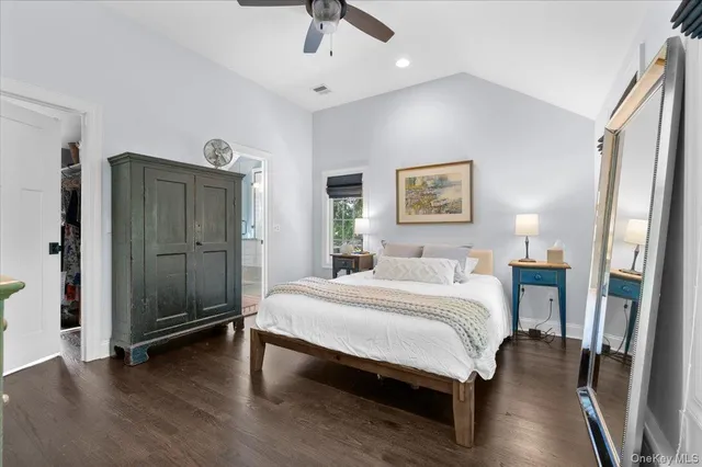 a spacious bedroom with a bed and a chandelier