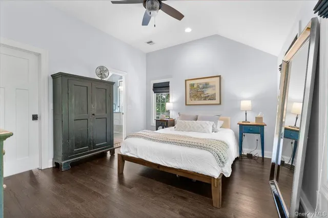 a spacious bedroom with a bed and a chandelier