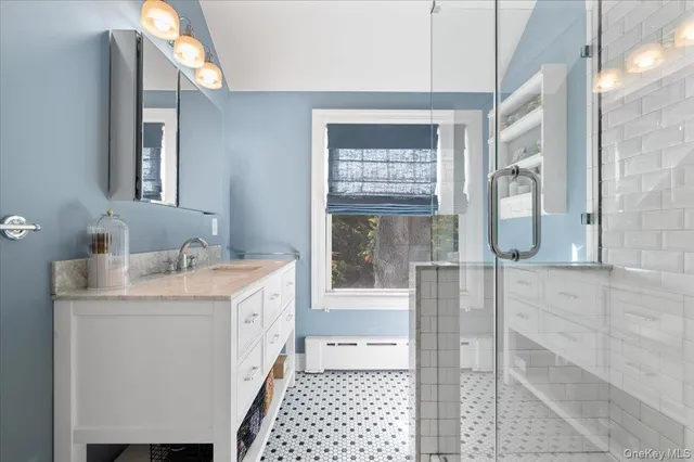 a bathroom with a granite countertop sink and a mirror