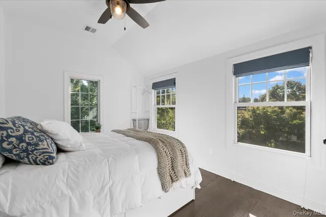 a bedroom with a large bed and a window
