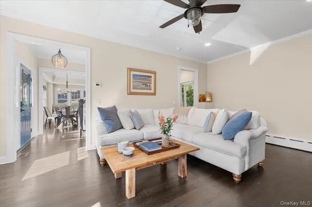 a living room with furniture and a table with wooden floor