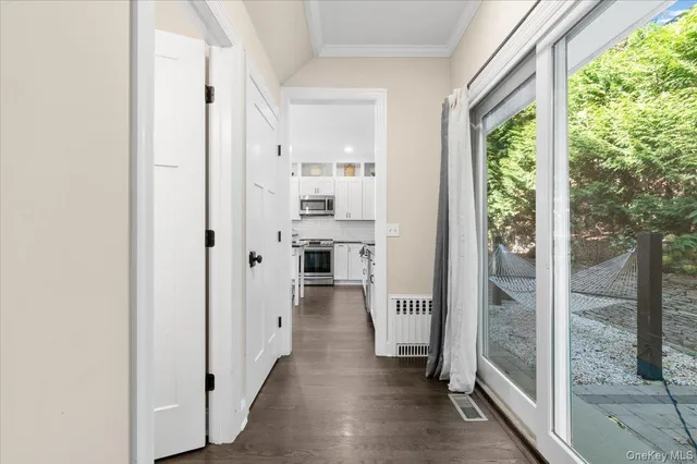 a view of a hallway with wooden floor and entryway