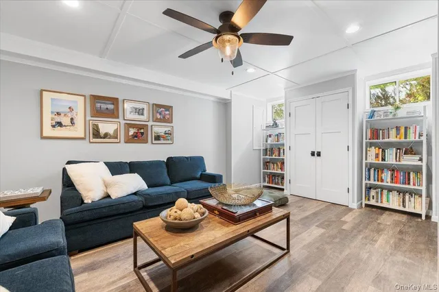 a living room with furniture and painting on the wall