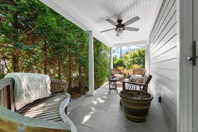 a view of a porch with furniture and a yard