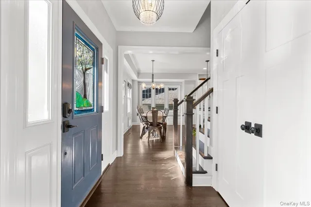 a view of entryway and hall with wooden floor