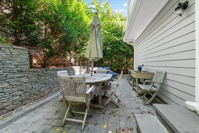 a view of a patio with table and chairs and potted plants