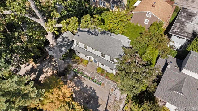 an aerial view of a house with a yard