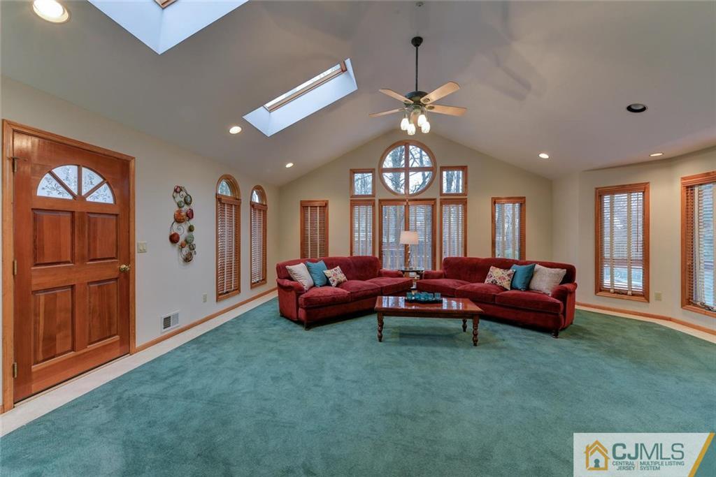 52 Hillsdale Road Edison, NJ 08820 - Photo 13 of 25 a living room with furniture and a chandelier
