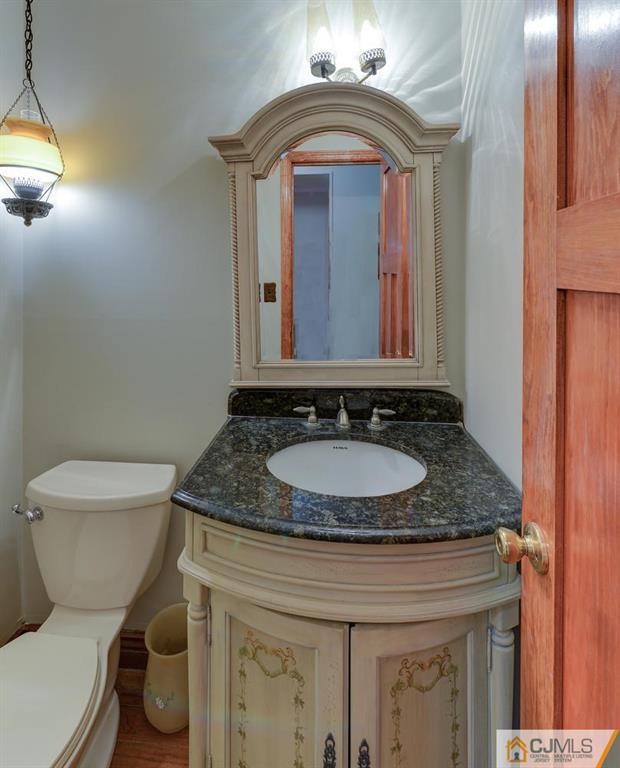 52 Hillsdale Road Edison, NJ 08820 - Photo 15 of 25 a bathroom with a granite countertop toilet sink and mirror