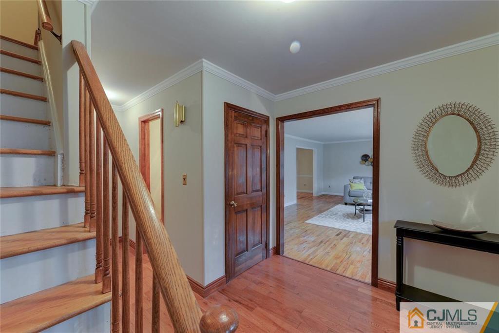 52 Hillsdale Road Edison, NJ 08820 - Photo 16 of 25 a view of a hallway with wooden floor and staircase
