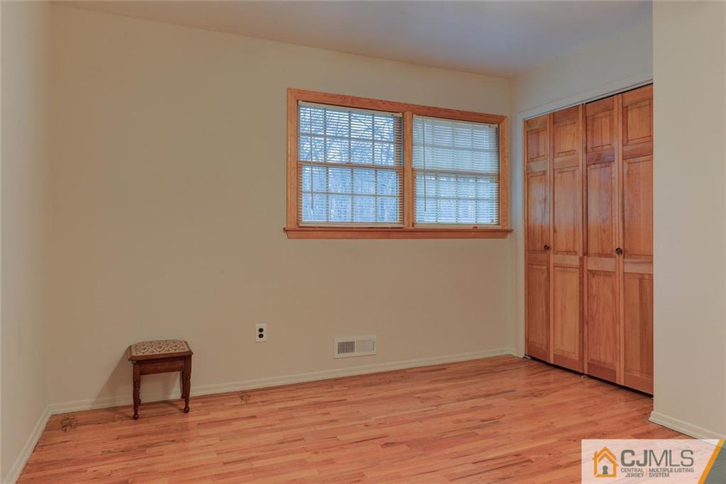 52 Hillsdale Road Edison, NJ 08820 - Photo 18 of 25 a view of an empty room with a window and wooden floor