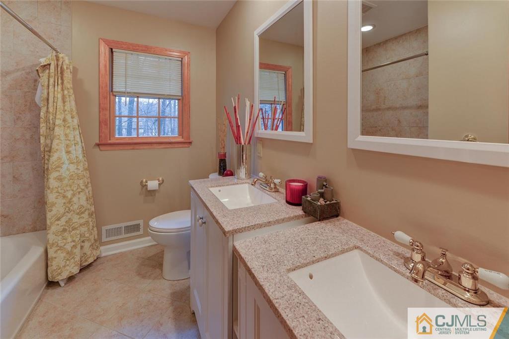 52 Hillsdale Road Edison, NJ 08820 - Photo 20 of 25 a bathroom with a granite countertop sink a toilet and a shower
