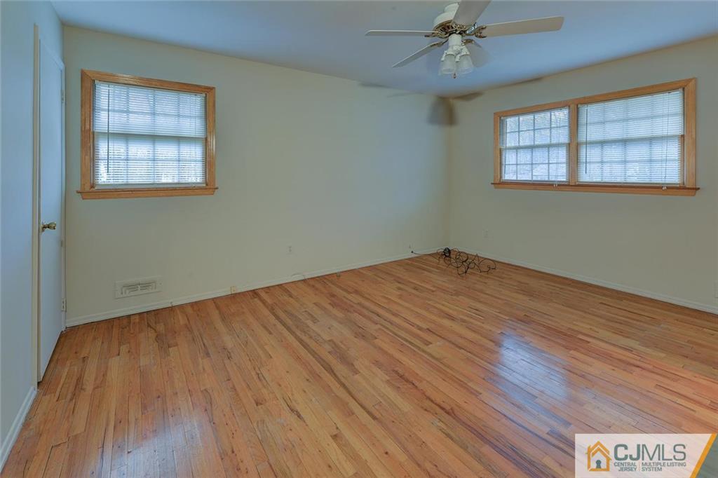 52 Hillsdale Road Edison, NJ 08820 - Photo 21 of 25 a view of empty room with wooden floor and fan