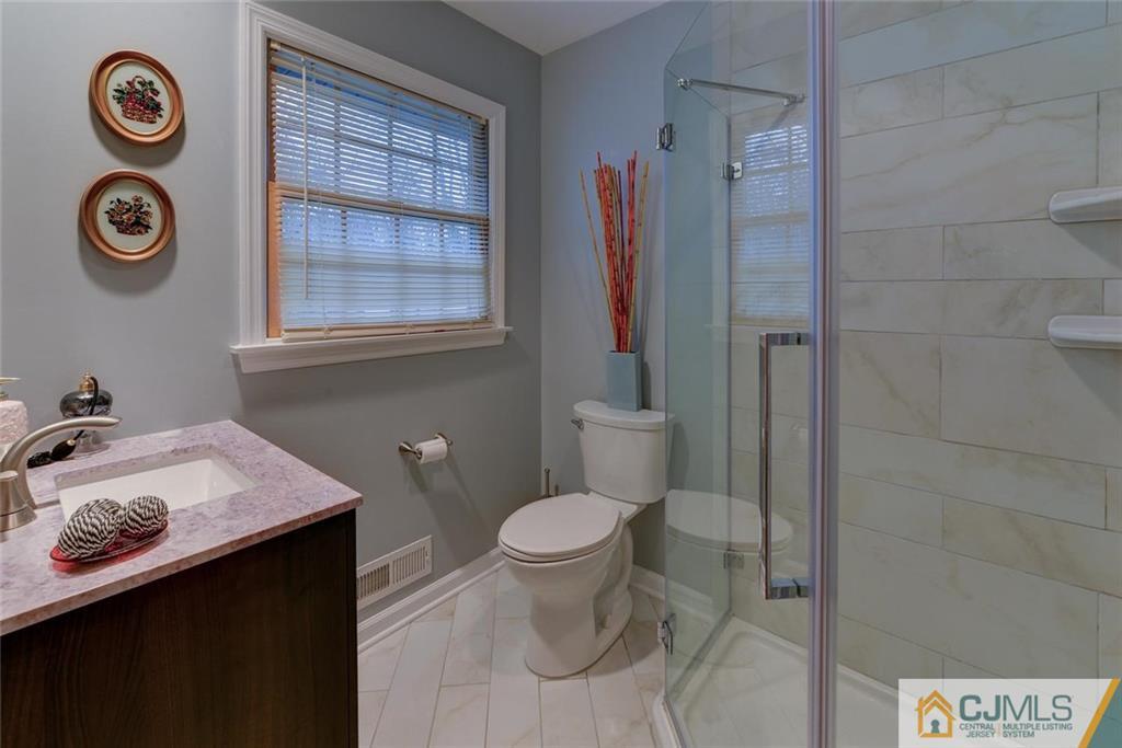 52 Hillsdale Road Edison, NJ 08820 - Photo 22 of 25 a bathroom with a toilet a sink and a window