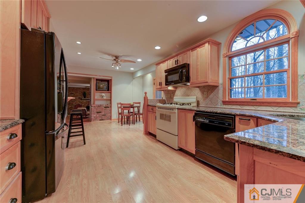52 Hillsdale Road Edison, NJ 08820 - Photo 8 of 25 a kitchen with stainless steel appliances granite countertop a stove top oven a sink a refrigerator and a microwave