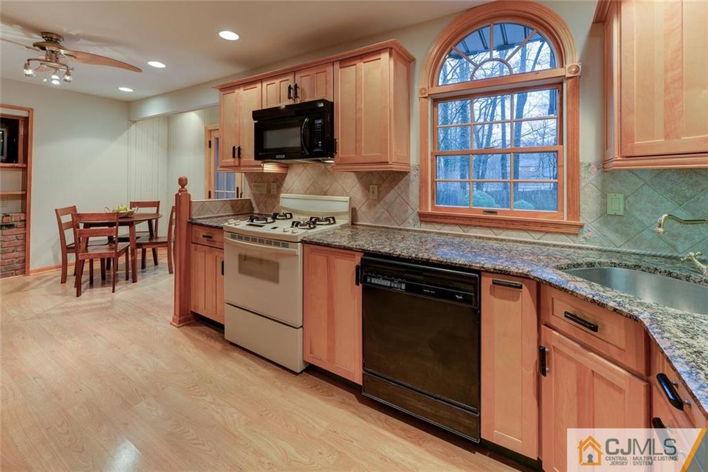 52 Hillsdale Road Edison, NJ 08820 - Photo 10 of 25 a kitchen with a stove a sink and a microwave
