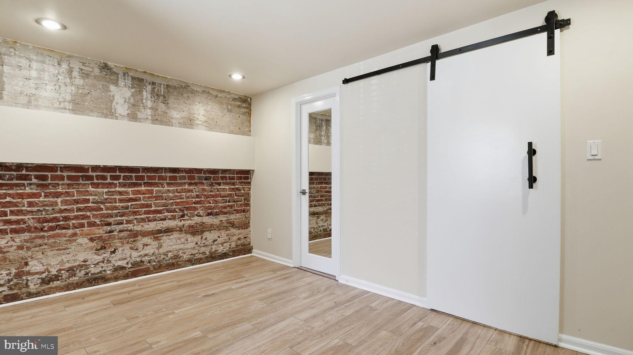 1450 Harvard Street Northwest, Unit B Washington, DC 20009 - Photo 18 of 35 a view of an empty room with wooden floor and a window