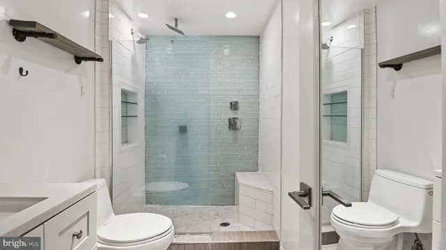 a bathroom with a shower a toilet and a sink